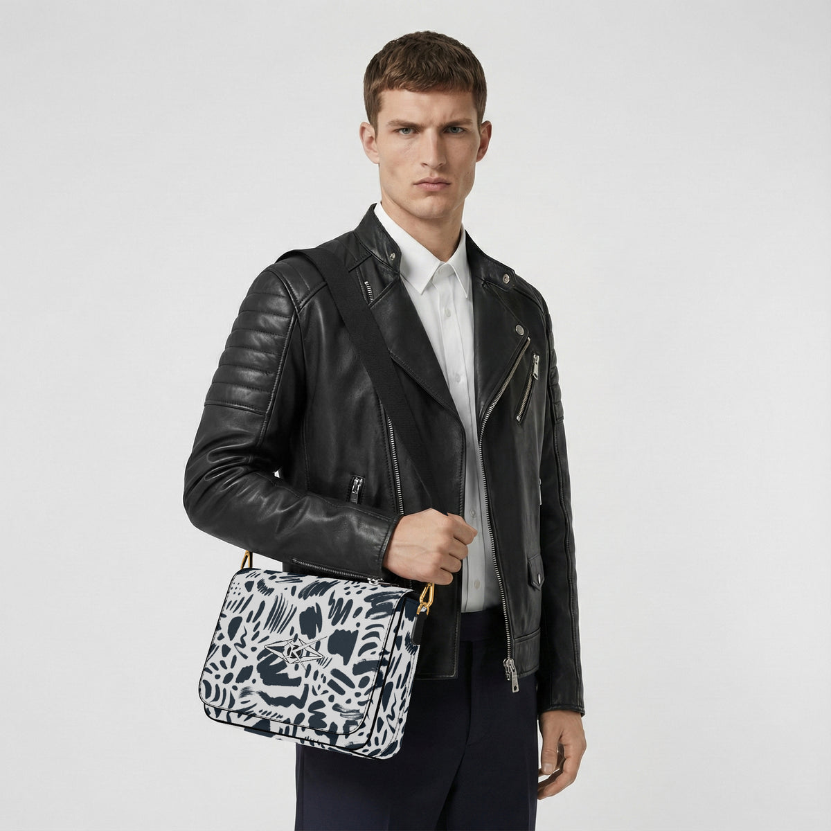 Man holding a Kreator Luxe Orion Crossbody bag against a white background