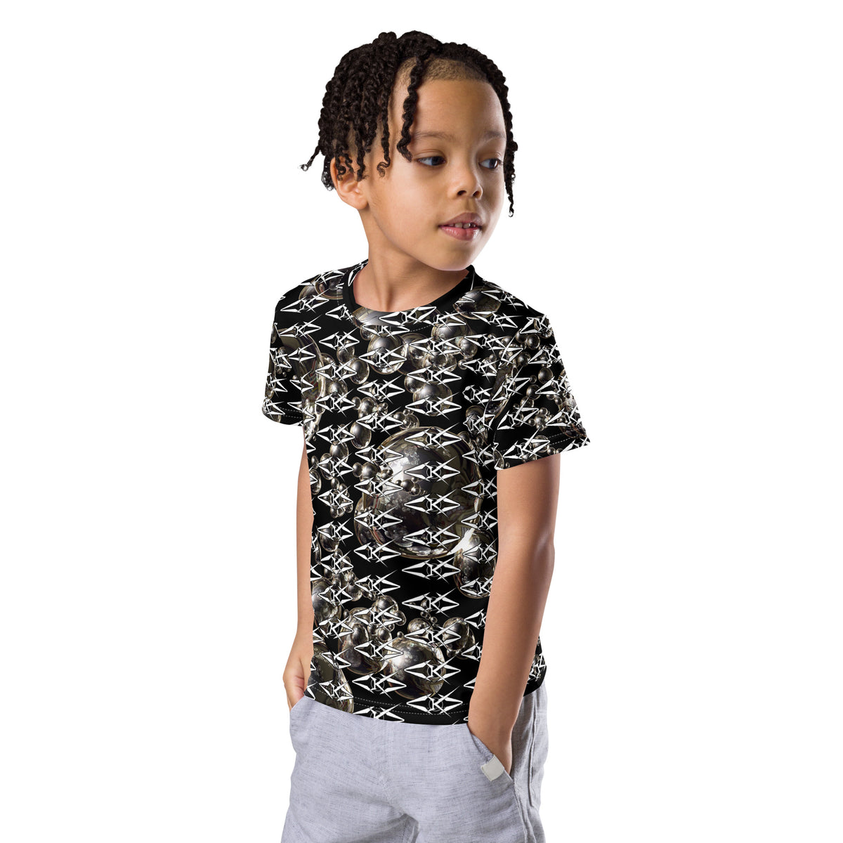 Child wearing a black and white patterned shirt on a white background