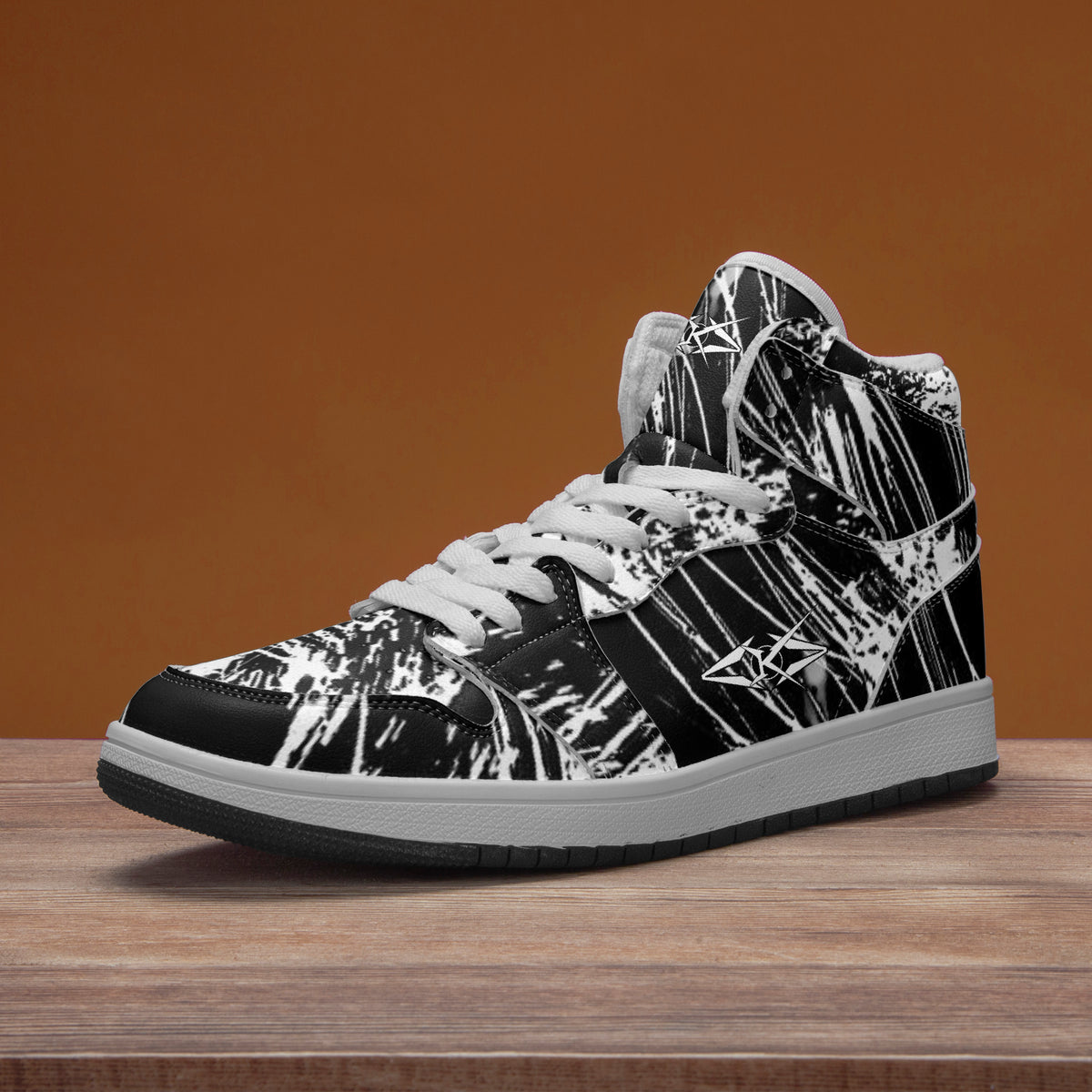 Black and white high-top sneaker on a wooden surface with a brown background
