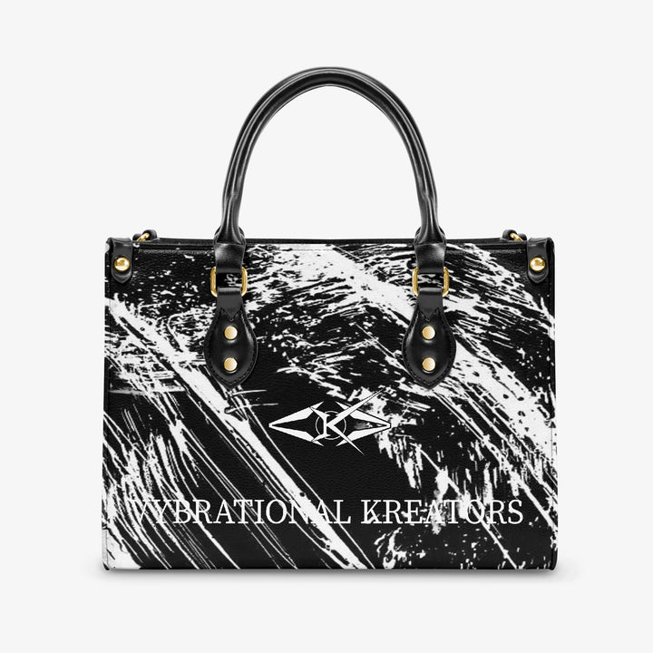 Onyx Flow Luxe tote bag by Vybrational Kreators featuring a black and white abstract flow pattern structured silhouette black top handles gold hardware and printed brand logo.